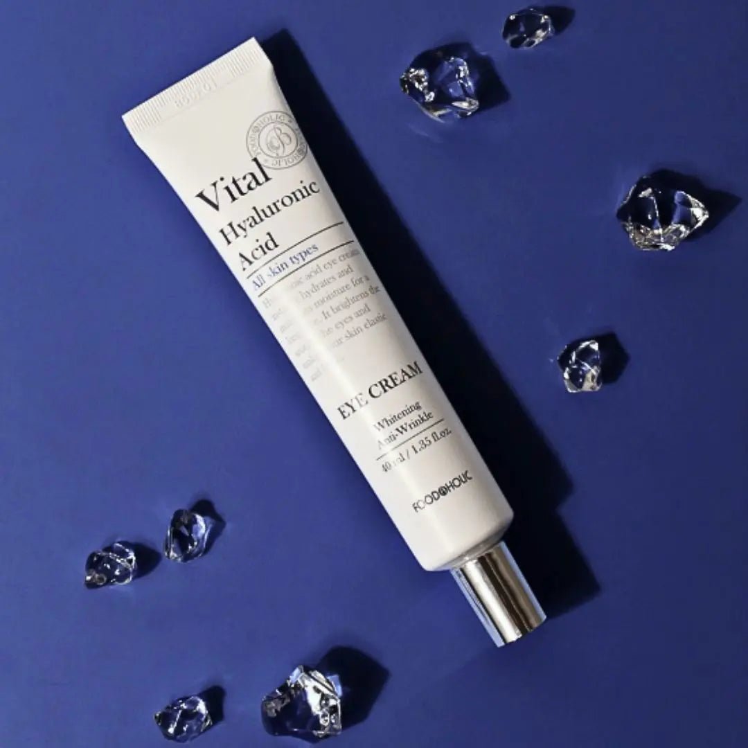Vital Hyaluronic Acid eye cream tube with crystals on a blue background