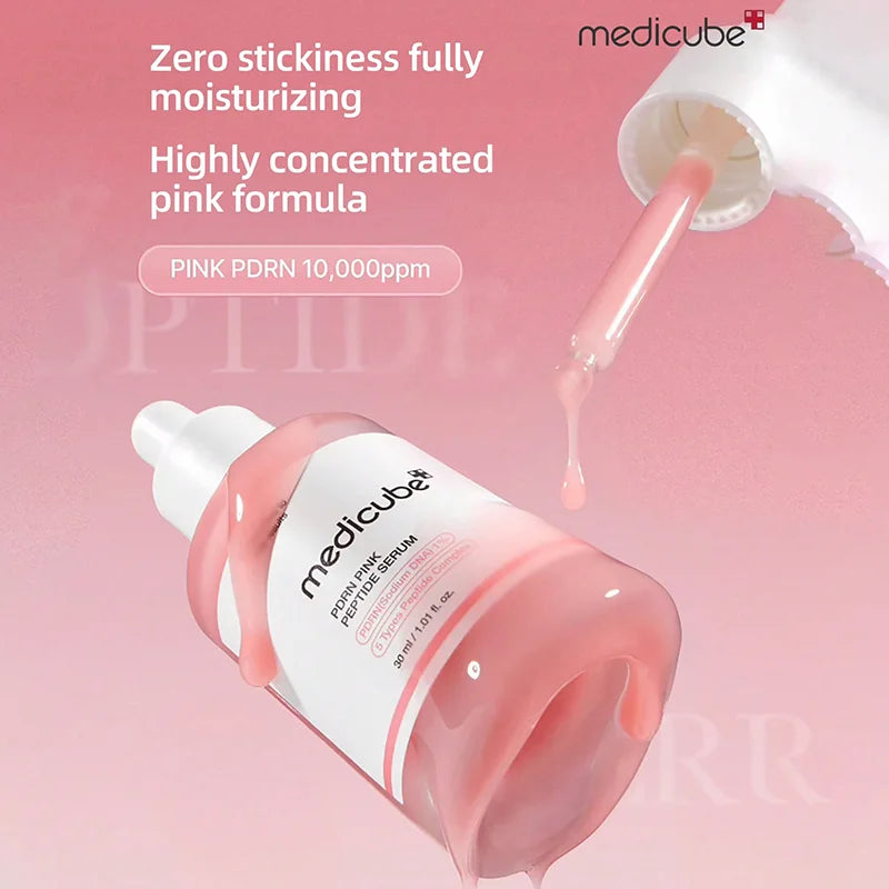 Medicube pink serum bottle with dropper on a pink background