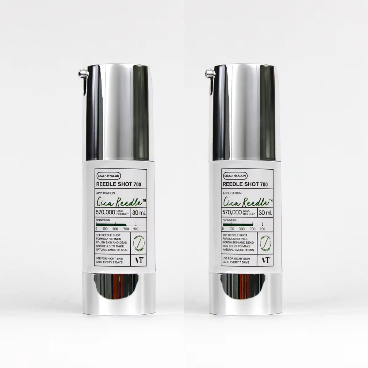Two silver skincare bottles with labels on a white background