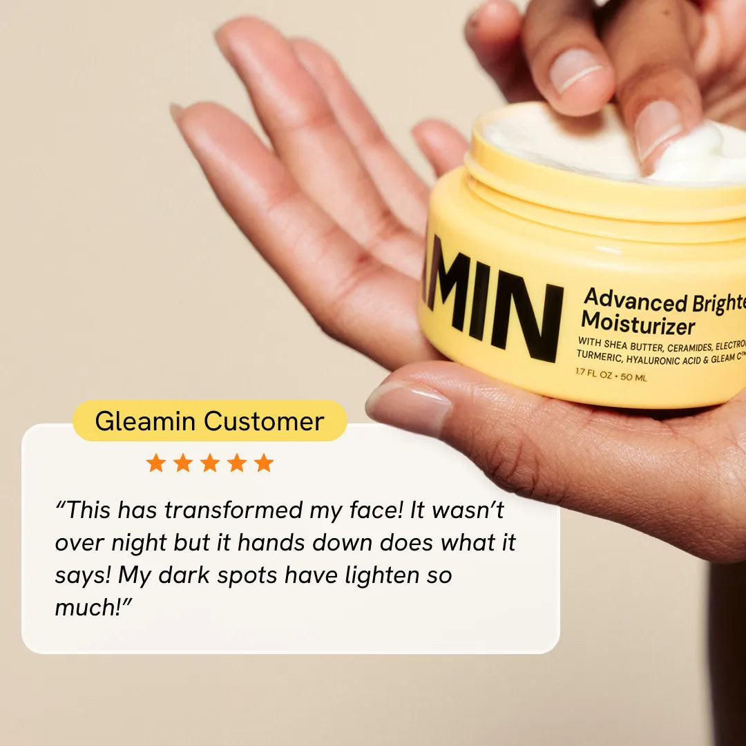 Customer holding GLEAMIN Advanced Brightening Moisturizer with 5-star review about dark spot results